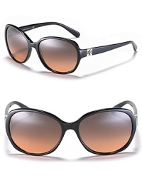 Glam it up in Tory Burch's round oversized sunglasses with a subtle signature logo at temples. Glam it up in Tory Burch's round oversized sunglasses with a subtle signature logo at temples.