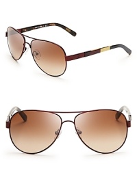 These Tory Burch aviators fly first class in fashion with ultra-chic colorblocked sides. These Tory Burch aviators fly first class in fashion with ultra-chic colorblocked sides.