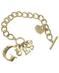 Strike up the brand. This logo bracelet from GUESS is crafted from gold-tone mixed metal with glass crystal accents adding a lustrous touch. Item comes packaged in a signature GUESS Gift Box. Approximate length: 7-1/2 inches. Approximate drop: 1 inch. Approximate diameter: 1-1/2 inches.