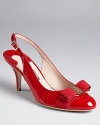 A logo ornament tops the grosgrain-wrapped toes of these chic, sleek patent heels. From Salvatore Ferragamo.