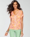 An abstract print, shiny studding and split-sleeve detail makes this top from INC so striking.
