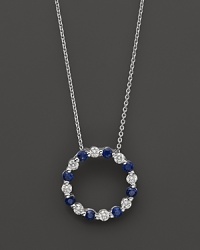 Diamond and sapphire circle pendant in 14K white gold. Diamond and sapphire circle pendant in 14K white gold.