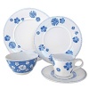 Give your day a cheery start. Bight blue flowers gleam from this white porcelain breakfast saucer.