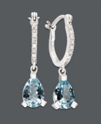 An elegant spin on the traditional hoop. Vibrant aquamarine teardrops (2 ct. t.w.) dangle dramatically from a 14k white gold hoop setting dusted in diamond accents. Approximate drop: 1/4 inch.