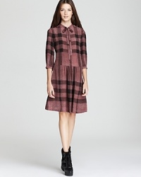 A drop-waist silhouette lends a new season spin to the classic Burberry Brit check dress, styled with edgy boots for a thoroughly modern statement. A drop-waist silhouette lends a new season spin to the classic Burberry Brit check dress, styled with edgy boots for a thoroughly modern statement.