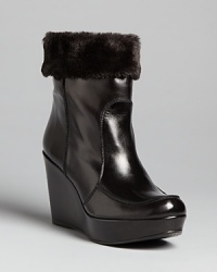 Designer Stuart Weitzman gives these versatile wedge booties a touch of luxe with plush, faux fur linings. Designer Stuart Weitzman gives these versatile wedge booties a touch of luxe with plush, faux fur linings.