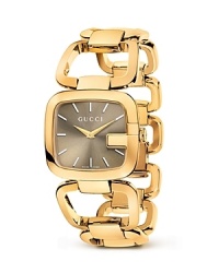 A Gucci bracelet watch with gold-tone links makes a luxe presentation with a sunbrushed dial. A Gucci bracelet watch with gold-tone links makes a luxe presentation with a sunbrushed dial.