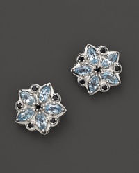 A floral shaped applique stud earring in sterling silver, accented with blue topaz and black spinel.