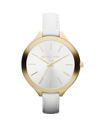 A pearly round dial finished in gold plated metal tops a slim, sophisticated Michael Kors watch set on pristine leather strap. A pearly round dial finished in gold plated metal tops a slim, sophisticated Michael Kors watch set on pristine leather strap.