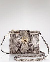 MICHAEL Michael Kors proves mini is all you need with this patent crossbody bag. With it's bold logo and glossy python embossed leather exterior, it's our pick for getting it right at night. MICHAEL Michael Kors proves mini is all you need with this patent crossbody bag. With it's bold logo and glossy python embossed leather exterior, it's our pick for getting it right at night.