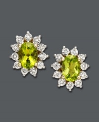 Add freshness to your look with a vibrant pop of color. Oval-cut peridot (9/10 ct. t.w.) gleams inside a ring of round-cut diamond accents. Post setting crafted in 14k gold and rhodium-plated 14k gold. Approximate diameter: 1/2 inch. Add freshness to your look with a vibrant pop of color. Oval-cut peridot (9/10 ct. t.w.) gleams inside a ring of round-cut diamond accents. Post setting crafted in 14k gold and rhodium-plated 14k gold. Approximate diameter: 1/2 inch.