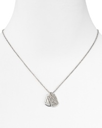 Let MICHAEL Michael Kors pavé dog tags brand an all-American look. This logo engraved design slips over basics and adds a touch of polish. Let MICHAEL Michael Kors pavé dog tags brand an all-American look. This logo engraved design slips over basics and adds a touch of polish.
