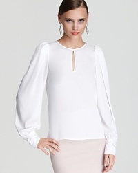 White hot and silky-soft, this BCBGMAXAZRIA blouse flaunts subtle puff sleeves and an alluring keyhole accent for a sophisticated look, rooted in elegant ease. White hot and silky-soft, this BCBGMAXAZRIA blouse flaunts subtle puff sleeves and an alluring keyhole accent for a sophisticated look, rooted in elegant ease.