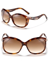 Balenciaga's chic oversized sunglasses feature a curving frame for a unique design. Balenciaga's chic oversized sunglasses feature a curving frame for a unique design.