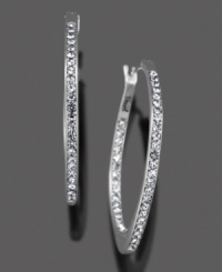 The classic hoop earring gets a grand update with a glittering row of round-cut crystal accents. In silvertone mixed metal. Each measures approximately 1-1/4 inches. The classic hoop earring gets a grand update with a glittering row of round-cut crystal accents. In silvertone mixed metal. Each measures approximately 1-1/4 inches.