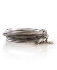 Add instant style with multiple layers. 24 bangle set by Jessica Simpson features intricate, textured bangles held together by a small chain and heart charm. Crafted in silver and hematite tone mixed metal. Approximate diameter: 2-1/2 inches.