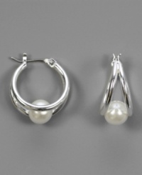 Precious glass pearls are hugged in dual hoops of shining silvertone mixed metal on these beautiful earrings by AK Anne Klein. Approximate diameter: 1 inch. Precious glass pearls are hugged in dual hoops of shining silvertone mixed metal on these beautiful earrings by AK Anne Klein. Approximate diameter: 1 inch.