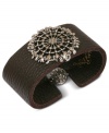 Brown leather and a detailed metal charm create Lucky Brand's stylish cuff bracelet. Set in silver and gold tone mixed metal with a ball closure. Crafted in brown leather. Approximate length: 7-5/8 inches.