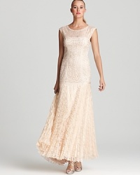Sue Wong's sleeveless gown lends a timeless look, mixing an embellished bodice with a delicately pleated lace skirt. A subtle dropwaist silhouette lends a trend-right look. Sue Wong's sleeveless gown lends a timeless look, mixing an embellished bodice with a delicately pleated lace skirt. A subtle dropwaist silhouette lends a trend-right look.