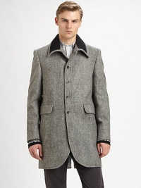 A distinguished wool top coat offering vintage style and modern details.Ribbed-knit detail along collarButton frontPatch pocketsBack ventAbout 35 from shoulder to hemWool; cotton liningMachine washImported