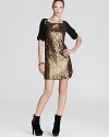 Ready for a party any night of the week, the cleverly constructed Wednesday dress glows with bold gold sequins and softly draping longer short sleeves.