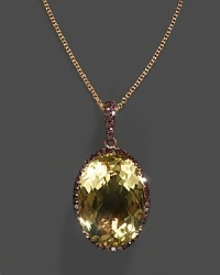 A lemon quartz pendant accented with brown diamonds on a yellow gold chain. A lemon quartz pendant accented with brown diamonds on a yellow gold chain.