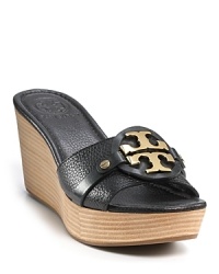 Tory Burch's bold, gleaming logo steals the show on these pebbled leather wedges. Tory Burch's bold, gleaming logo steals the show on these pebbled leather wedges.