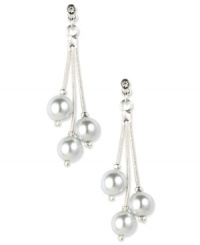 Start your date night with confidence with these elegant drop earrings by Anne Klein. Three white plastic pearls are suspended from glass stone-accented posts. Crafted in imitation rhodium-plated mixed metal. Approximate drop: 2 inches. Start your date night with confidence with these elegant drop earrings by Anne Klein. Three white plastic pearls are suspended from glass stone-accented posts. Crafted in imitation rhodium-plated mixed metal. Approximate drop: 2 inches.