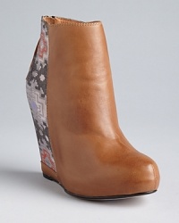 Ella Moss takes the tribal trend into lofty wedges with double the personality. Ella Moss takes the tribal trend into lofty wedges with double the personality.