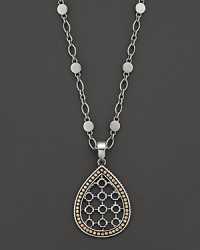 John Hardy's Dot pendant necklace lends a modern look with a teardrop shaped, geometric design in 18K yellow gold and sterling silver. John Hardy's Dot pendant necklace lends a modern look with a teardrop shaped, geometric design in 18K yellow gold and sterling silver.