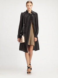 Timelessly tailored trenchcoat articulated in a striped silk silhouette. Point collarGathered necklineEpauletsButton frontLong sleeves with buttoned cuffsSelf-beltBack storm flap; ventAbout 42 from shoulder to hemSilkDry cleanImportedModel shown is 5'10 (177cm) wearing US size 4. Timelessly tailored trenchcoat articulated in a striped silk silhouette. Point collarGathered necklineEpauletsButton frontLong sleeves with buttoned cuffsSelf-beltBack storm flap; ventAbout 42 from shoulder to hemSilkDry cleanImportedModel shown is 5'10 (177cm) wearing US size 4.