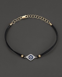 Diamonds and blue sapphires in 14K. yellow gold from a dazzling evil eye charm, strung on a leather rope. By Meira T. Diamonds and blue sapphires in 14K. yellow gold from a dazzling evil eye charm, strung on a leather rope. By Meira T.