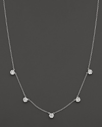 Five diamond cluster stations in a 14K white gold necklace.