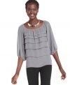 Studio M's tiered blouse features a feminine fit and a scoop neckline worthy of a statement necklace!
