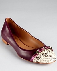 A snake embossed cap toe contrasts against smooth leather on Elie Tahari's Gwen ballet flats. A metallic leather buckle strap adds a hit of hardware. A snake embossed cap toe contrasts against smooth leather on Elie Tahari's Gwen ballet flats. A metallic leather buckle strap adds a hit of hardware.