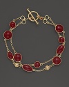 Two rows of bright red enamel stations and diamond accents highlight this bracelet from Roberto Coin.
