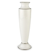 Pearl-like enamel dots enhance a creamy leaf design that encircles the top of this exquisite vase. An opalescent finish provides a lustrous background for the design. And four bands of precious platinum complete the elegant look. The vase makes a lovely bridesmaid gift. Made is crafted of Lenox white bone china and accented with precious platinum.Height: 8 1/8