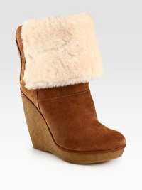 Plush shearling luxes up this suede versatile design that can be folded down, atop a rubber wedge and platform. Rubber wedge, 4¾ (120mm)Rubber platform, 1 (25mm)Compares to a 3¾ heel (95mm)Unfolded: shaft, 10Unfolded: leg circumference, 13Suede upperBack zip and secured by snaps when foldedShearling liningRubber solePadded insoleImported Plush shearling luxes up this suede versatile design that can be folded down, atop a rubber wedge and platform. Rubber wedge, 4¾ (120mm)Rubber platform, 1 (25mm)Compares to a 3¾ heel (95mm)Unfolded: shaft, 10Unfolded: leg circumference, 13Suede upperBack zip and secured by snaps when foldedShearling liningRubber solePadded insoleImported