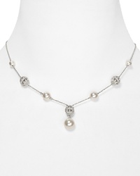 A strand of shimmering simulated pearls take on a new state of grace on this Nadri necklace, accented by an elegant crystal-adorned filigree pendant. A strand of shimmering simulated pearls take on a new state of grace on this Nadri necklace, accented by an elegant crystal-adorned filigree pendant.