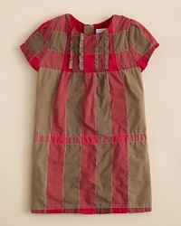 A traditional charm infuses this cute cap-sleeve dress, rendered with a ruffled chest and Burberry's signature check print allover. A traditional charm infuses this cute cap-sleeve dress, rendered with a ruffled chest and Burberry's signature check print allover.