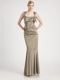 A flattering trumpet silhouette defines this lustrous taffeta design.Square necklineSide bow accent with beaded detailSleevelessRuched bodiceDrop waistTrumpet skirtConcealed back zipFully linedAbout 49 from natural waistSelf; 74% acetate/18% nylon/8% spandexLining; polyesterDry cleanMade in USA of imported fabricModel shown is 5'10 (177cm) wearing US size 4.OUR FIT MODEL RECOMMENDS ordering true size. A flattering trumpet silhouette defines this lustrous taffeta design.Square necklineSide bow accent with beaded detailSleevelessRuched bodiceDrop waistTrumpet skirtConcealed back zipFully linedAbout 49 from natural waistSelf; 74% acetate/18% nylon/8% spandexLining; polyesterDry cleanMade in USA of imported fabricModel shown is 5'10 (177cm) wearing US size 4.OUR FIT MODEL RECOMMENDS ordering true size.