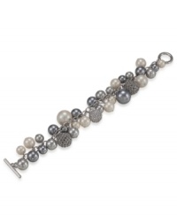 A cluster full of class. This chunky bracelet by Carolee features glittering fireballs, white glass pearls, charcoal glass pearls, and pewter glass pearls. Crafted in silvertone mixed metal with a toggle and bar closure. Approximate length: 8 inches. A cluster full of class. This chunky bracelet by Carolee features glittering fireballs, white glass pearls, charcoal glass pearls, and pewter glass pearls. Crafted in silvertone mixed metal with a toggle and bar closure. Approximate length: 8 inches.