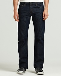 J Brand's five pocket slim straight leg jeans with zip fly and button closure. Dark wash denim with no fading or distressing. Slight whiskering in front. Signature stitch on back pockets. J Brand's five pocket slim straight leg jeans with zip fly and button closure. Dark wash denim with no fading or distressing. Slight whiskering in front. Signature stitch on back pockets.