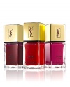 A new generation nail lacquer that's both elegant and practical is presented in a sleek, elongated glass bottle imprinted with the timeless YSL logo. Long-wear formula with Chile Rose Oil strengthens, moisturizes and protects nails from chipping and cracking. Dries fast and applies evenly without streaking. La Laque Couture is equipped with a new, custom-made brush that allows an easy and fast application. The nail lacquer perfectly adheres to the brush, which pulls the drop instead of pushing it for a flawless and intense result. The La Lacque Trio Holiday Set includes three full-size lacquers: N1 Rouge Pop Art, N6 Rouge Dada and N9 Fuchsia Intemporal.