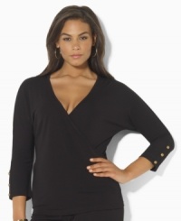 Slinky matte jersey creates a figure-flattering faux-wrap plus size design, tailored with three-quarter sleeves and anchor-embossed buttons for a hint of seaside chic, from Lauren by Ralph Lauren. Slinky matte jersey creates a figure-flattering faux-wrap plus size design, tailored with three-quarter sleeves and anchor-embossed buttons for a hint of seaside chic, from Lauren by Ralph Lauren.