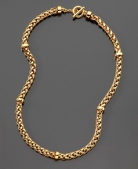 Strength and beauty are embodied in this classic woven goldtone toggle necklace by Lauren Ralph Lauren. Approximate length: 18 inches.