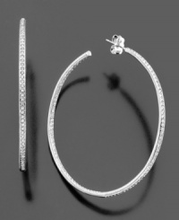 Add subtle luster to any ensemble with these brilliant hoop earrings, in silvertone rhodium plated mixed metal with clear crystals. Measures approximately 2 inches in diameter. Add subtle luster to any ensemble with these brilliant hoop earrings, in silvertone rhodium plated mixed metal with clear crystals. Measures approximately 2 inches in diameter.