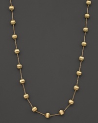 Textured bead stations lend bold style to this 18 karat gold necklace from Marco Bicego.