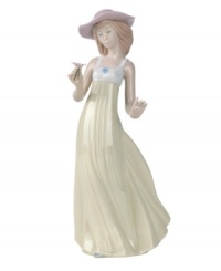 A picture-perfect still of grace and beauty, this handmade porcelain figure presents a young belle admiring a flower as her dress flutters behind; an ideal gift that sparks care-free joy within any special someone. A picture-perfect still of grace and beauty, this handmade porcelain figure presents a young belle admiring a flower as her dress flutters behind; an ideal gift that sparks care-free joy within any special someone.