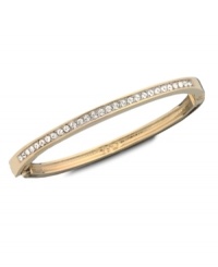 Drape your wrist in gold! Clear Swarovski crystal set in the traditional pavé style creates mesmerizing sparkle all around this gold tone mixed metal hinged bangle. Approximate diameter: 3 inches.